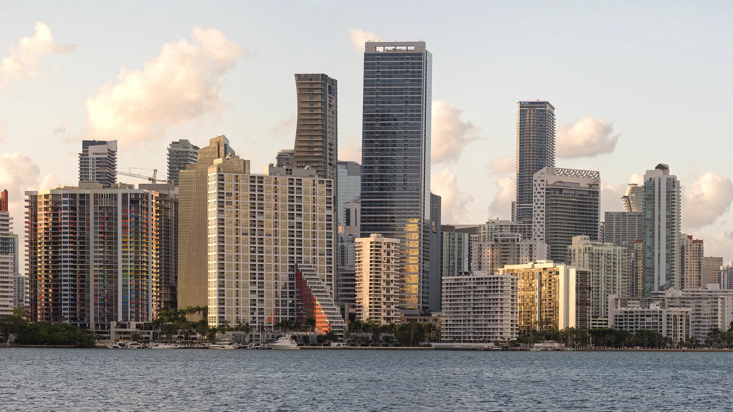 Miami’s Brickell skyline across Biscayne Bay in golden evening light