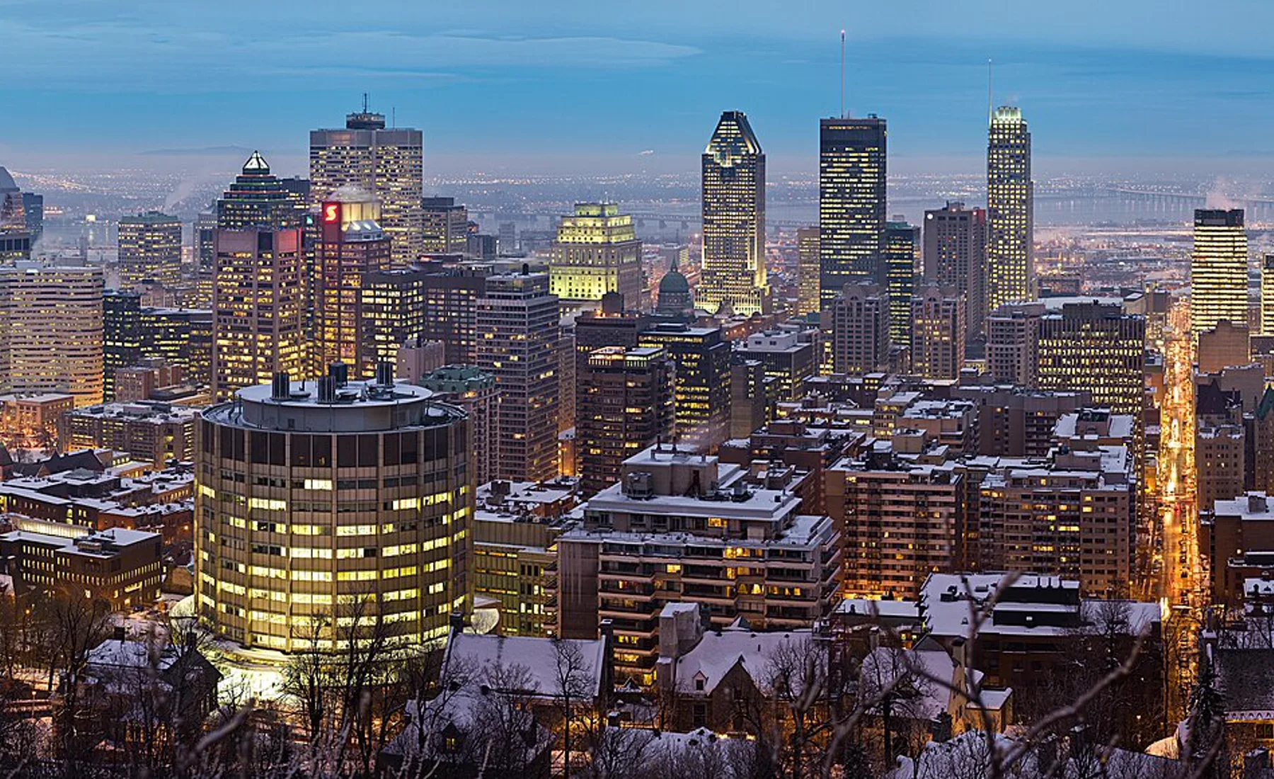 Montréal's skyline glowing beside the St. Lawrence River