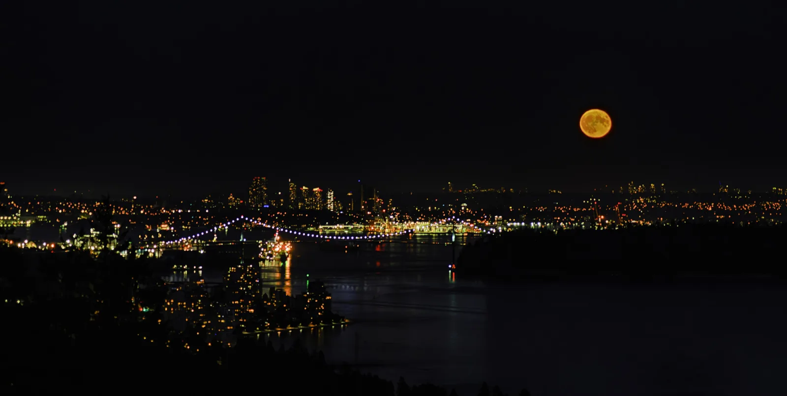 Vancouver's waterfront skyline under a blue moon